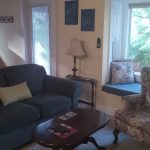 Suite sitting area with sofa, armchair and garden window