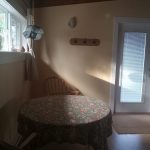 Armchair and round table beside the garden window