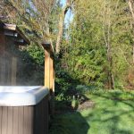 Hot tub beside the wooded garden
