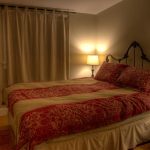 Queen sized bed with bedside lamps